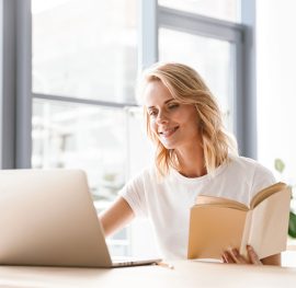 smiling-businesswoman-working-on-laptop-computer-JNUZS4R.jpg